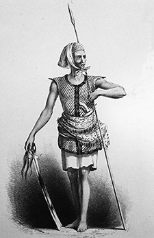 An “Iranun” sea-warrior attired in the distinctive thick cotton quilted red vest, and armed with a long spear and kampilan, a long heavy “lanoon sword” ornamented with human hair as described in The Global Economy and the Sulu Zone: Connections, Commodities and Culture.